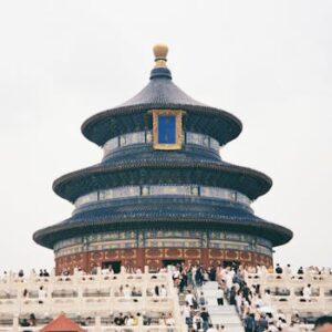 Temple of Heaven in Beijing surrounded by tourists during the day.